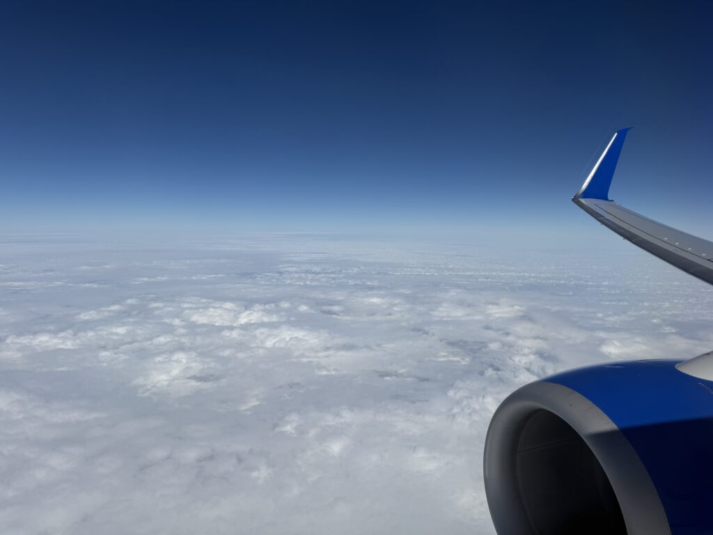 Scenic airplane window view during long-haul international flight to romantic destination
