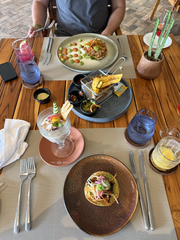 Luxury dining table with gourmet cuisine and tropical cocktails - romantic travel dining experience