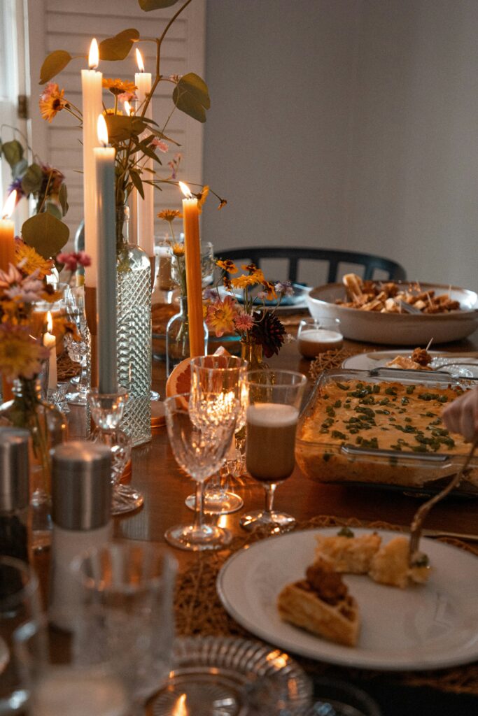 Elegant Thanksgiving table setting with autumn flowers, taper candles, and holiday dishes - sophisticated wine pairing dinner entertaining ideas