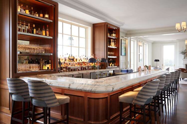 Crawford's bar at featuring elegant marble countertop, craft cocktails, and sophisticated lounge seating in Charlottesville Virginia