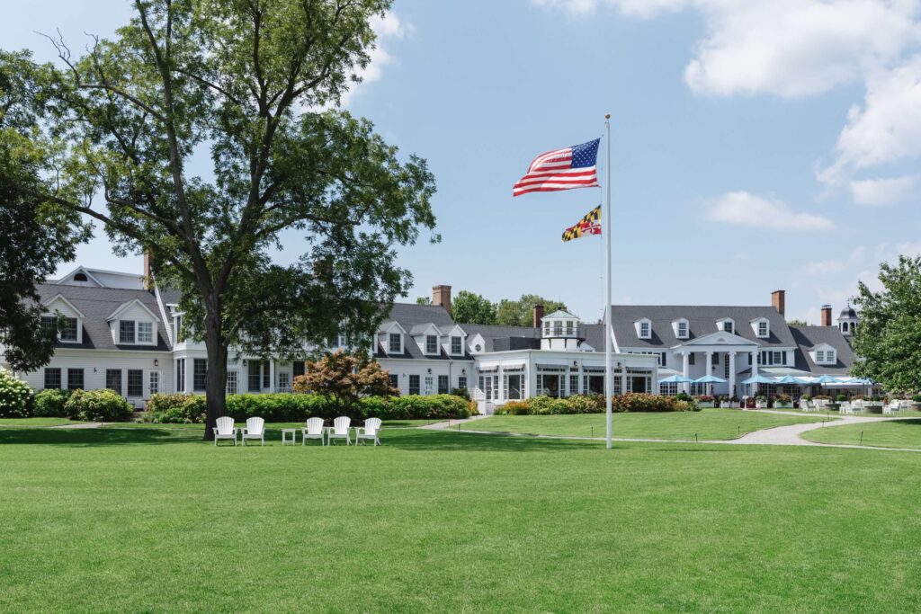 Inn at Perry Cabin St Michaels Maryland waterfront resort with Adirondack chairs and American flag