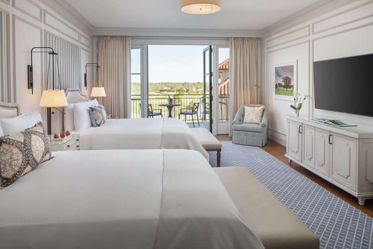 Luxury guest room with two queen beds, golf course views, and private balcony perfect for friend getaways in Virginia wine country