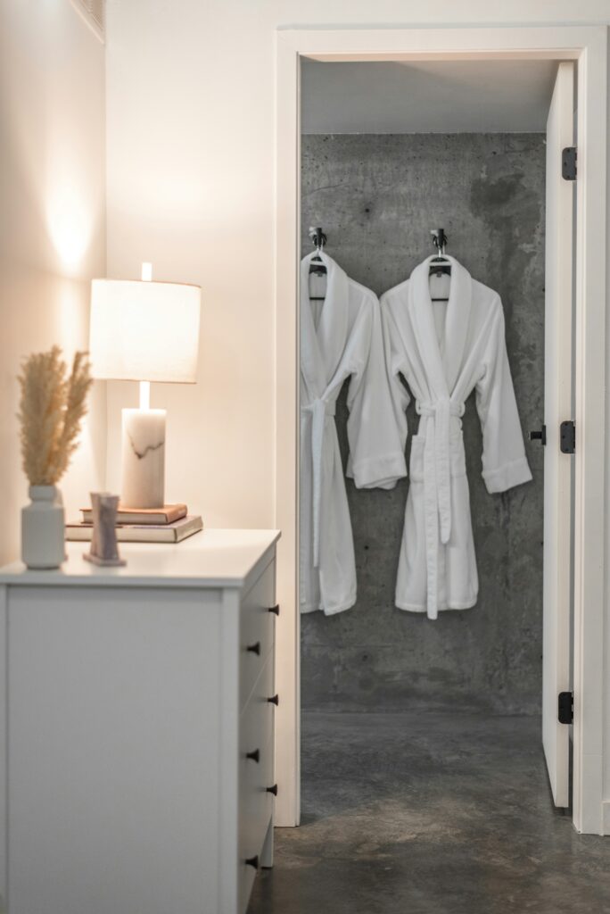 Luxury spa robes hanging in modern hotel bathroom for romantic couples weekend getaway