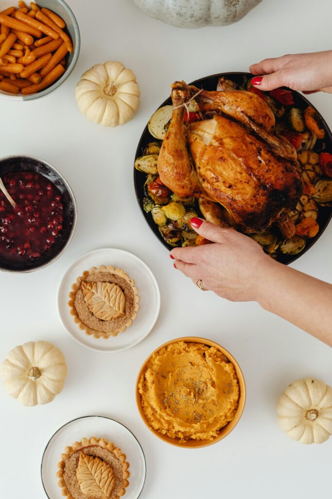 Roasted Thanksgiving turkey with cranberry sauce, sweet potatoes and holiday sides - complete turkey dinner for wine pairing recommendations