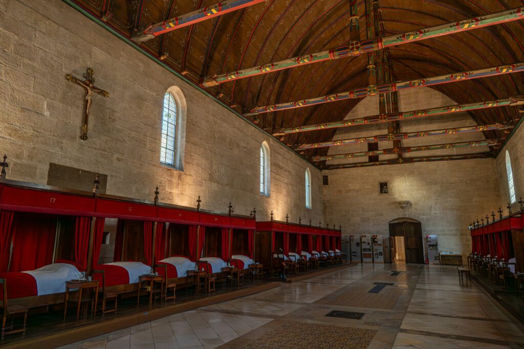 Historic Hospices de Beaune wine auction hall with colorful timber ceiling, iconic Burgundy wine heritage site