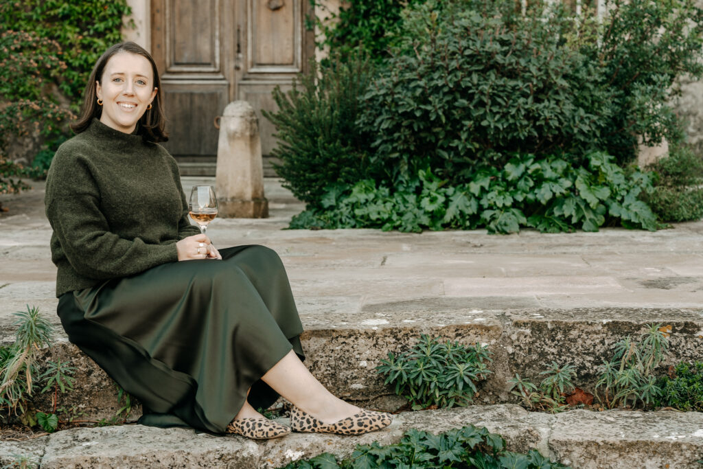 Kathryn Davidson, wine and food travel advisor with a glass of rose wine in European winery