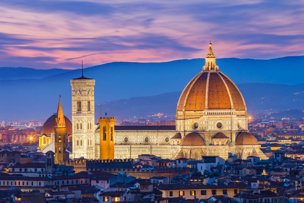 Florence Cathedral Duomo at sunset in Florence Italy with city skyline and Tuscan hills
