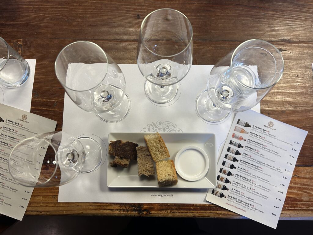 Wine tasting at Avignonesi winery in Montepulciano Tuscany with glasses and bread for palate cleansing