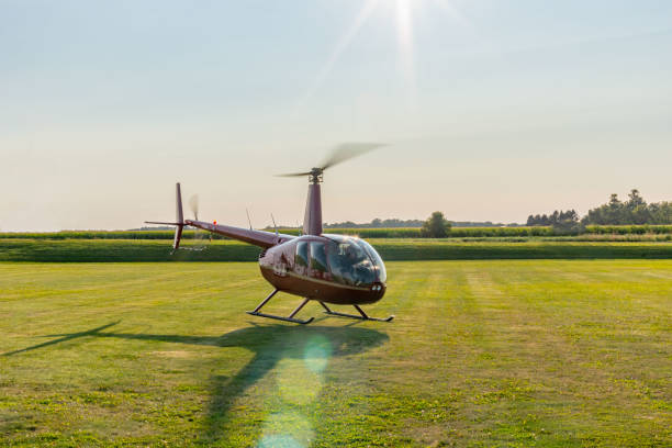 Helicopter on a grassy field offering private transfer to a European wine region