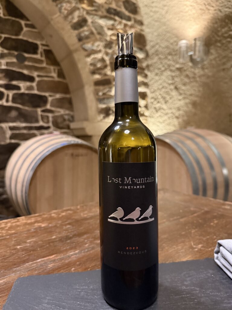 Bottle of Rendezvous wine from Lost Mountain Vineyards displayed in the barrel cellar in Delaplane Virginia.