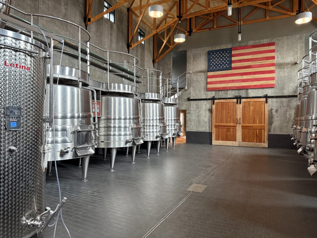Stainless steel fermentation tanks inside the winery production room at Lost Mountain Vineyards in Virginia wine country.
