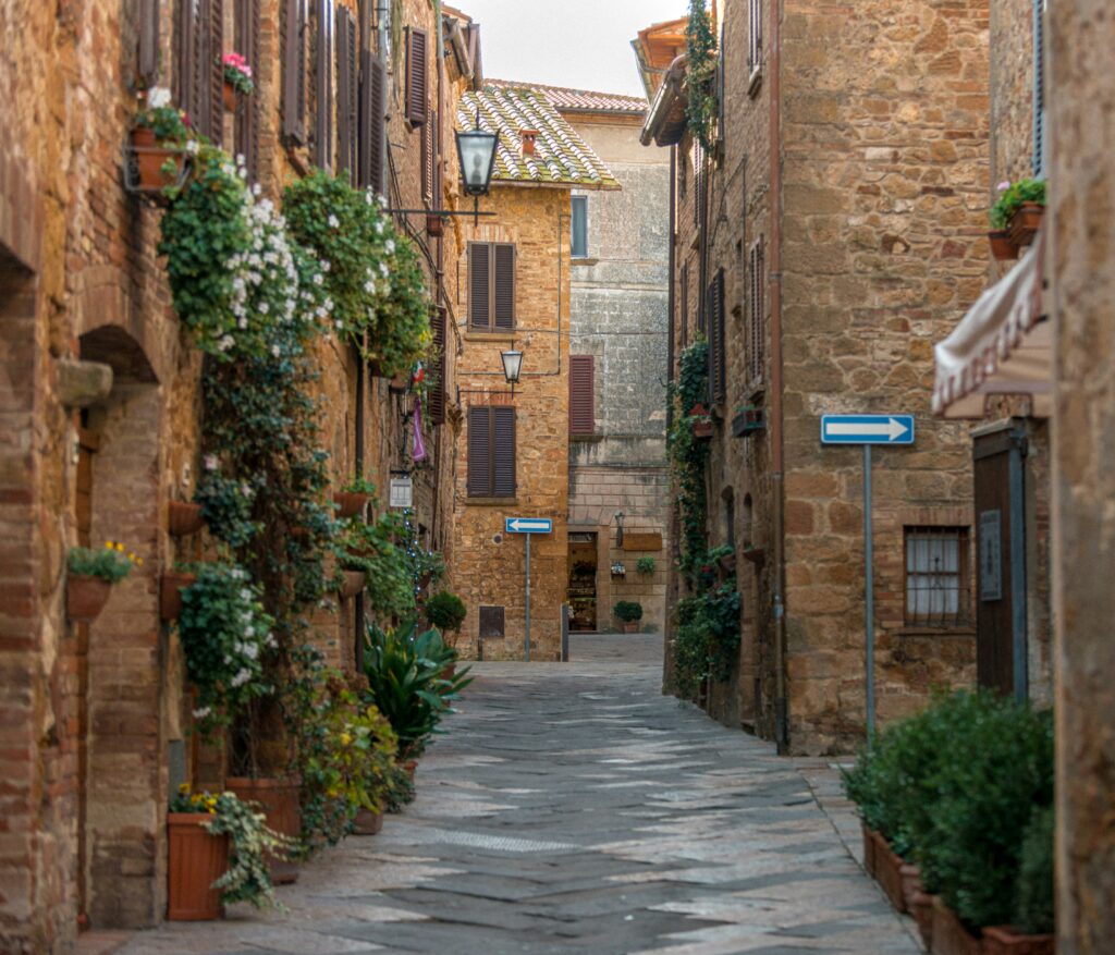Stone street in the hill town of Cortona, Tuscany lined with historic buildings and flower boxes