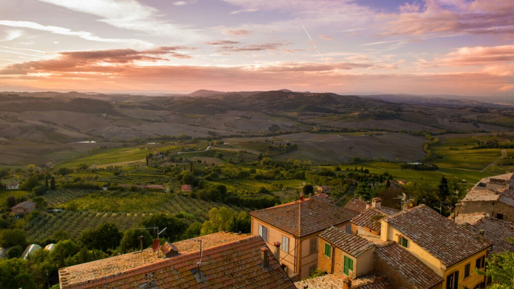 Tuscan countryside at sunset with vineyards and hill towns near San Gimignano Italy